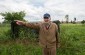 Edward M., born in 1928, standing in his meadow in Wola Okrzejska where a mass grave was dug for the 36 victims murdered by the Germans on December 28, 1942. ©Les Kasyanov/Yahad - In Unum